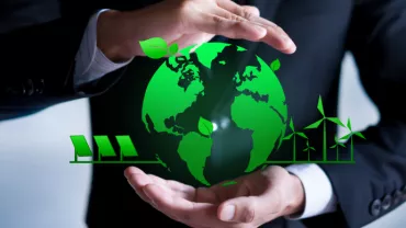 Mains entourant un globe vert avec des icônes écologiques.