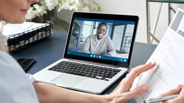 Personne participant à un entretien vidéo sur un ordinateur portable.