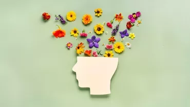 Silhouette d'une tête avec des fleurs colorées en jaillissant