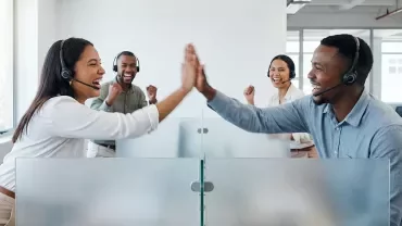 Un homme et une femme au travail contents se tapent dans la main