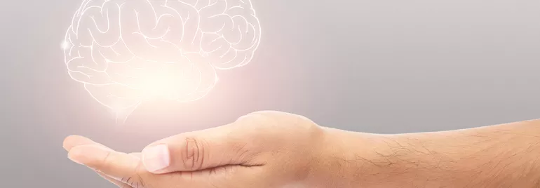 Main tenant une image numérique de cerveau lumineux.