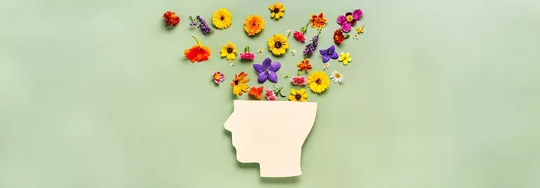 Silhouette d'une tête avec des fleurs colorées en jaillissant