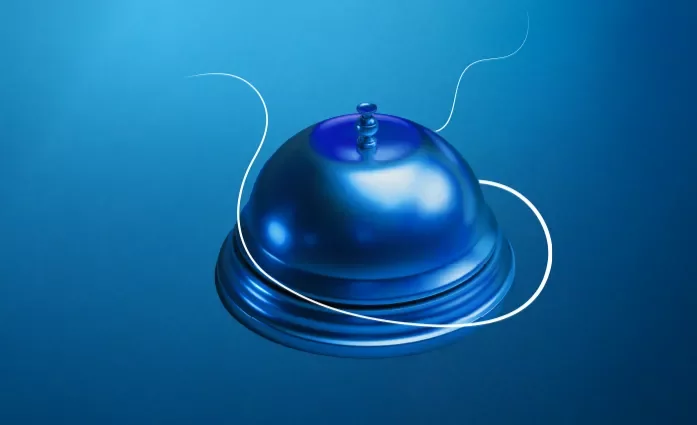 Une sonnette d'hôtel sur un fond bleu dégradé